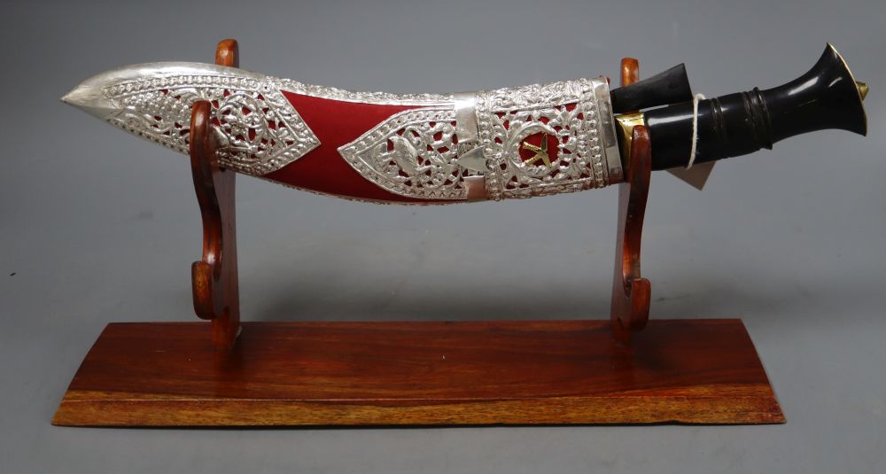 A decorative model of a kukri on stand